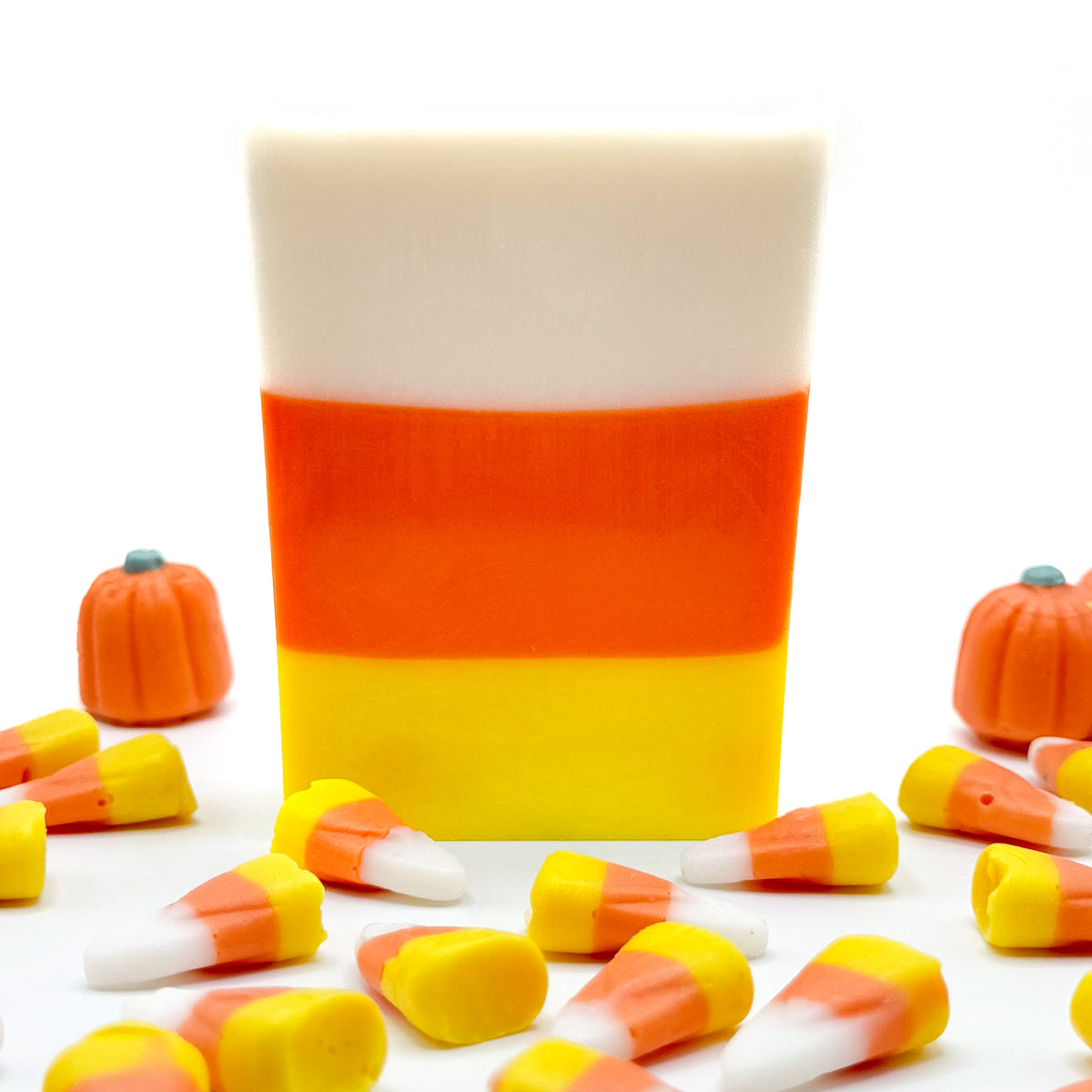 Multiple triangle and square shaped candy corn soap. The layers of colors start with yellow on the bottom, orange in the middle and white on top.