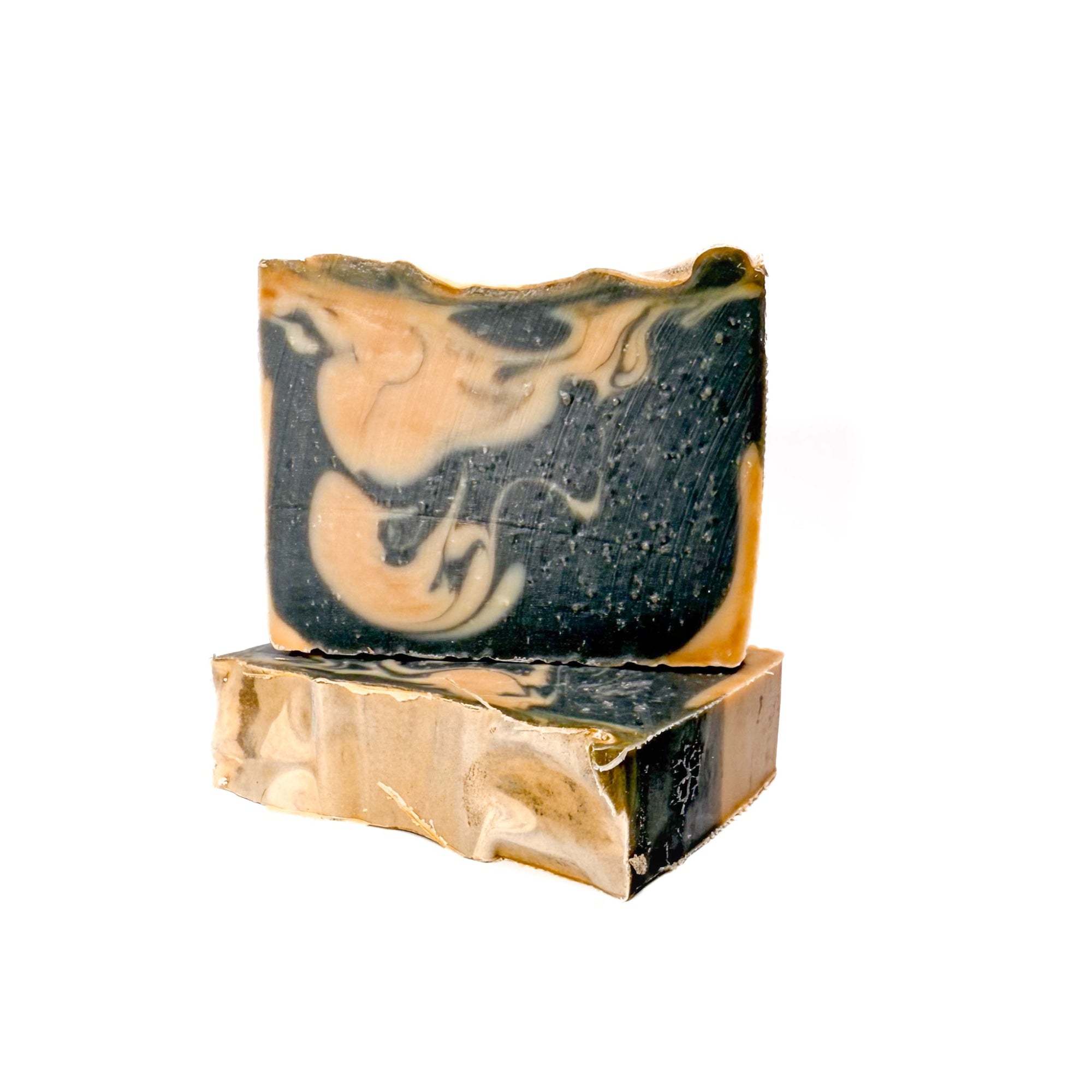 Two bars of Cashmere natural bar soap handmade by Rusted Acre Soap Co. Black and tan in color.