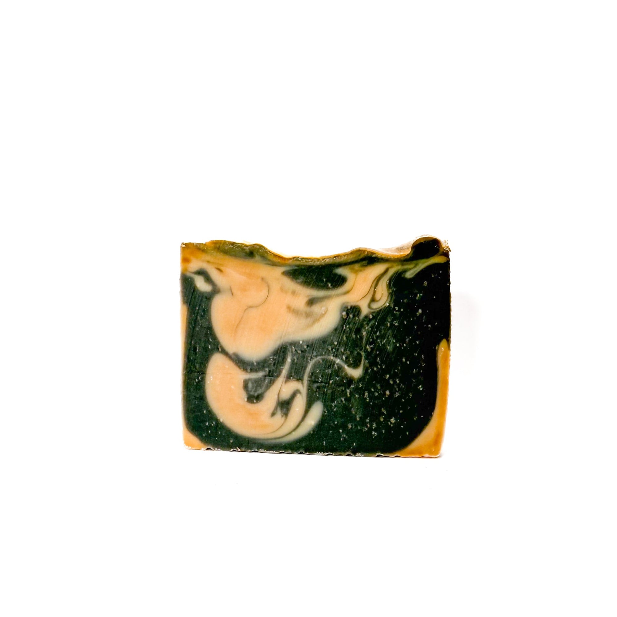 A bar of Cashmere natural bar soap handmade by Rusted Acre Soap Co. The colors are black and tan.