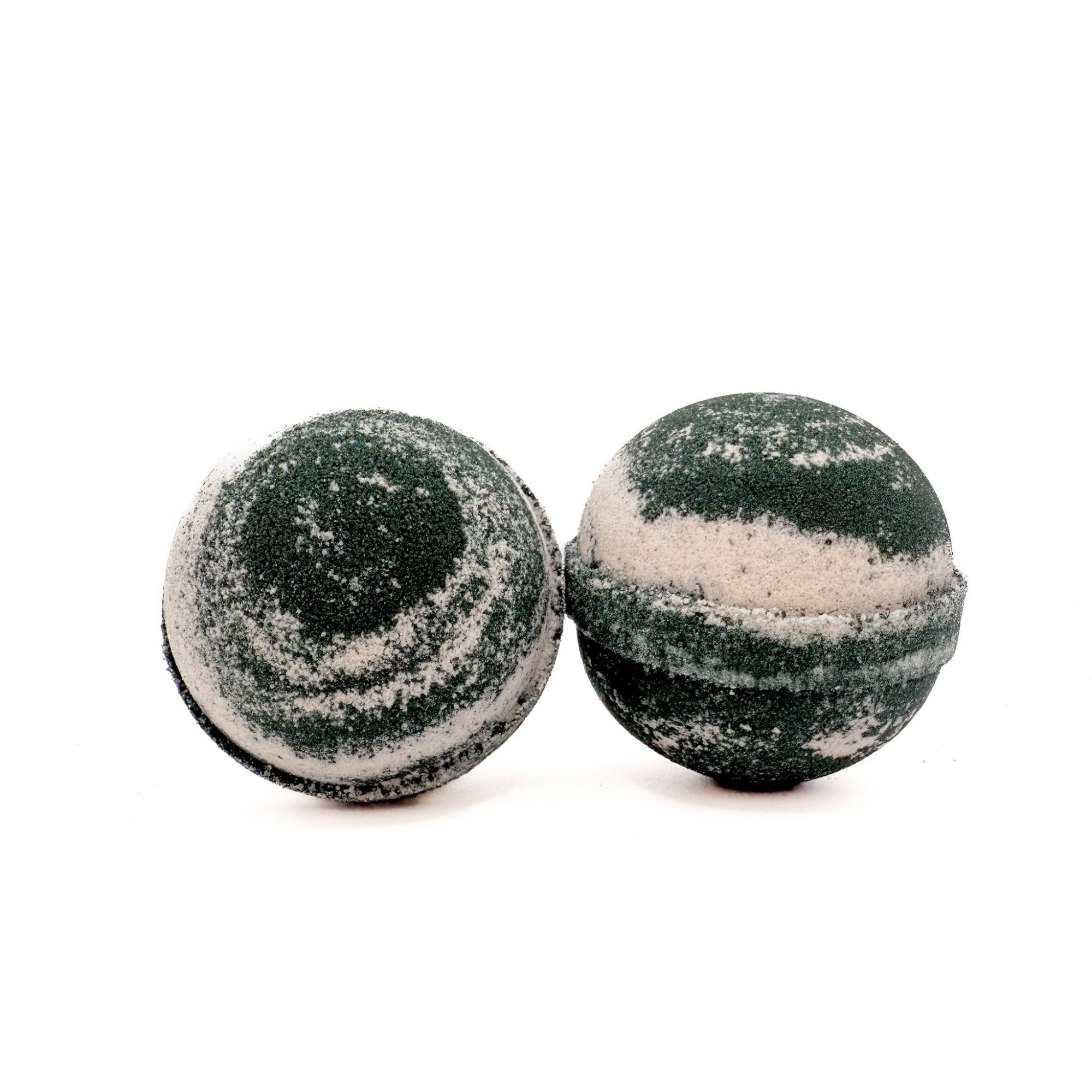 Two handmade round Cashmere bath bombs, black and tan in color, from Rusted Acre Soap Co.
