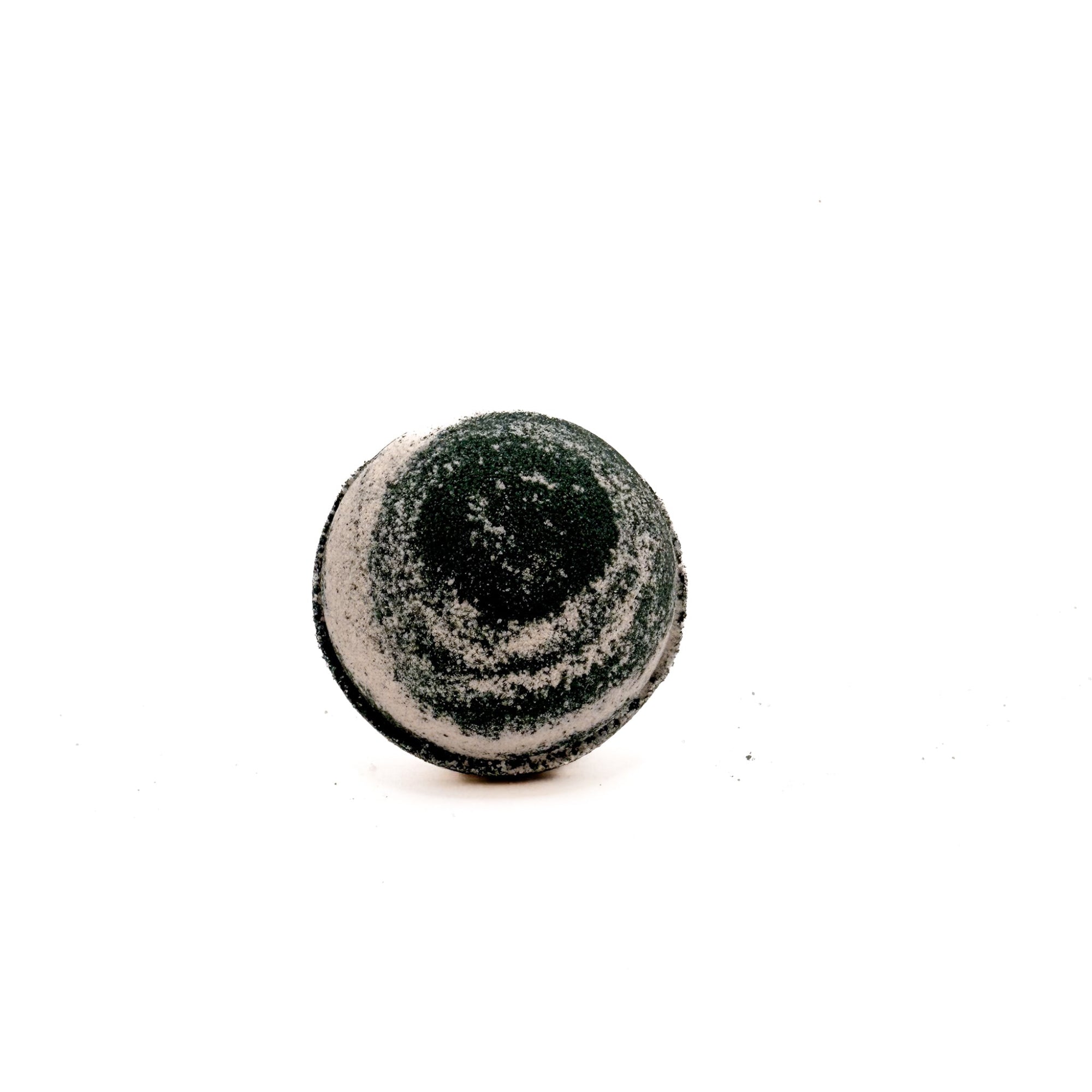 A handmade round Cashmere bath bomb from Rusted Acre Soap Company. Black and tan swirled mix.