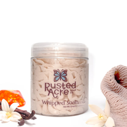 Jar of Rusted Acre Soap Company's vegan cashmere whipped soap. Light tan soap in a reusable plastic jar in a lifestyle setting. 