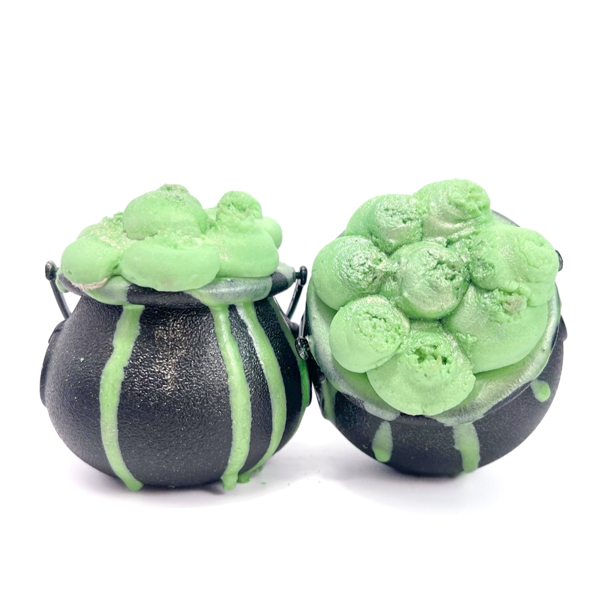Two witches Cauldron bath bombs with green bubble frosting.  