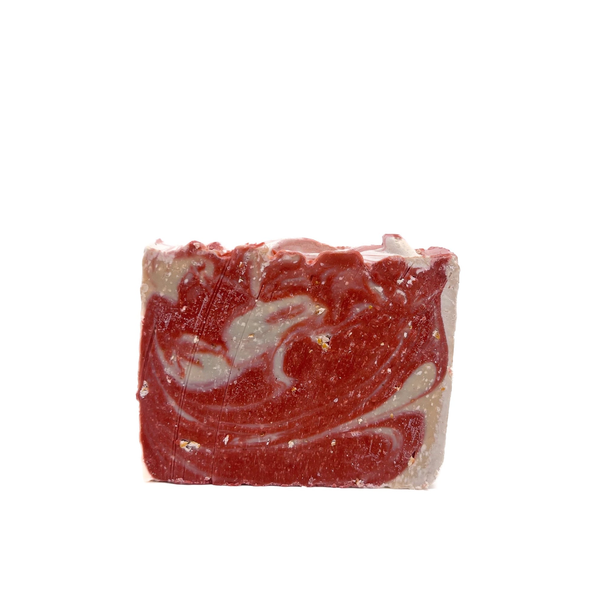 A bar of red and natural white swirled handmade soap scented with cherry almond from Rusted Acre Soap Co.