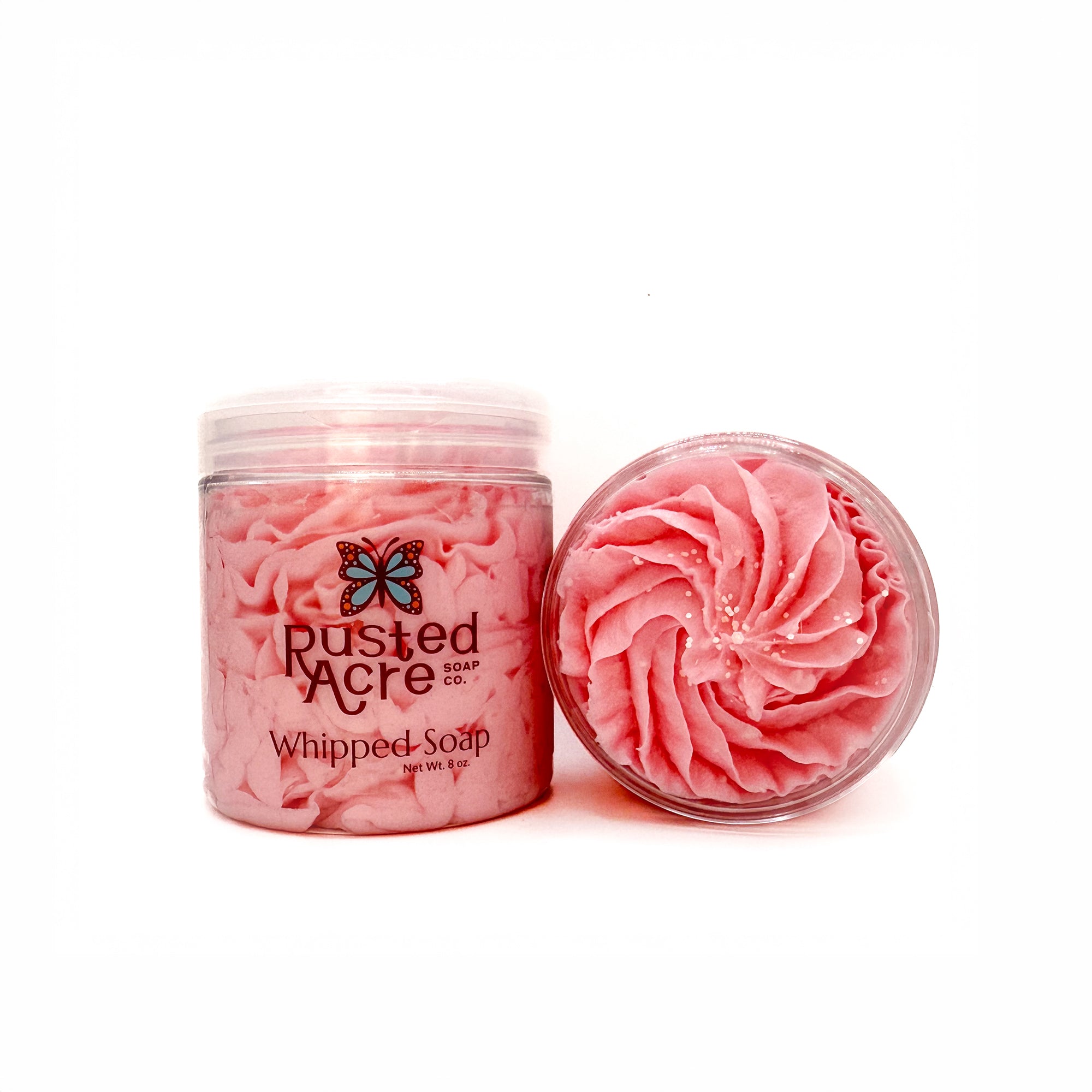 Two jars of Rusted Acre Soap Company’s cherry blossom whipped soap front and top view.