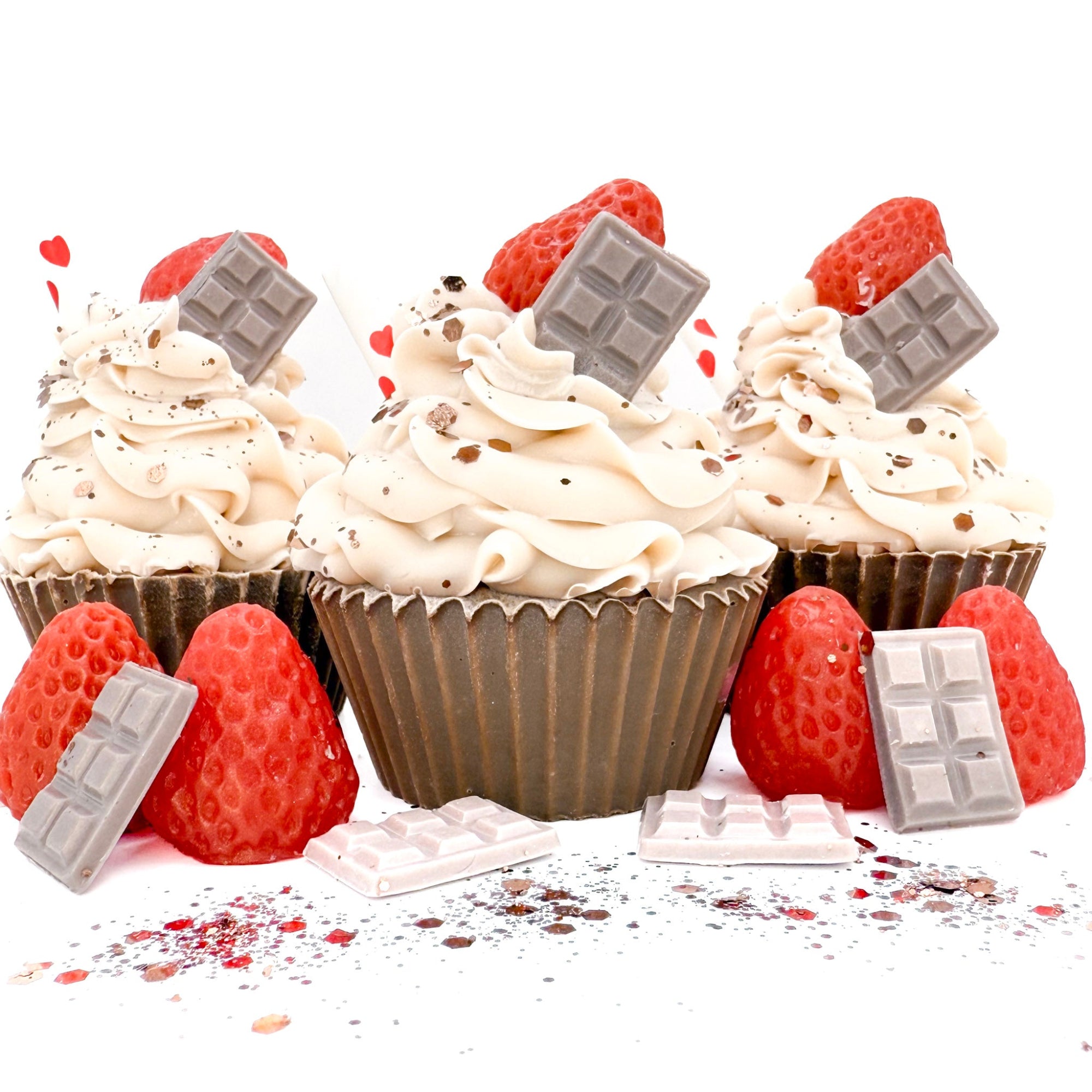 Three handmade chocolate strawberry cupcake soaps from Rusted Acre Soap Company. Chocolate brown cake and white frosting. Topped with chocolate soap bar, strawberry shaped soap and a straw.