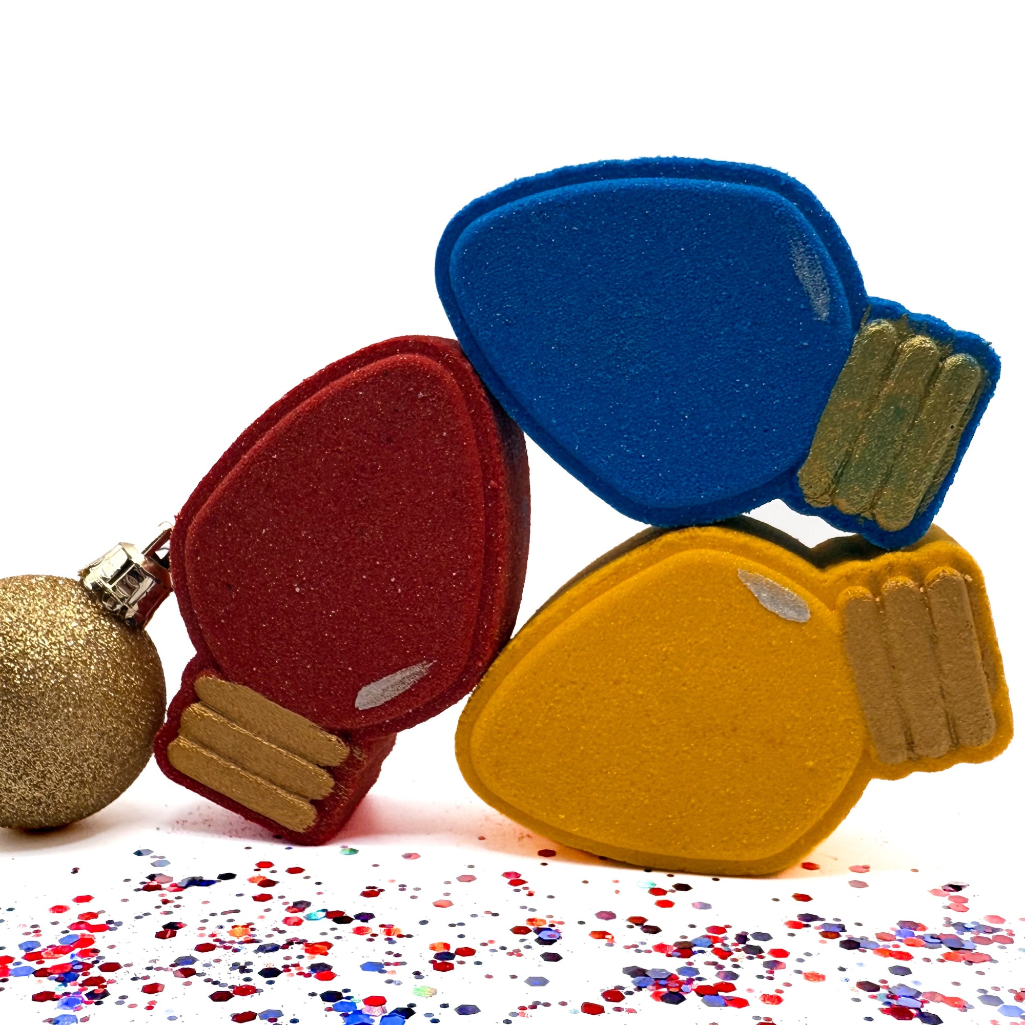Three holiday light bulb bath bombs hand made by Rusted Acre Soap Co. Yellow, Red and Blue.