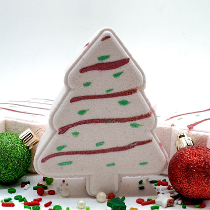 Decorative Christmas tree-shaped bath bomb with red and green accents on a white background