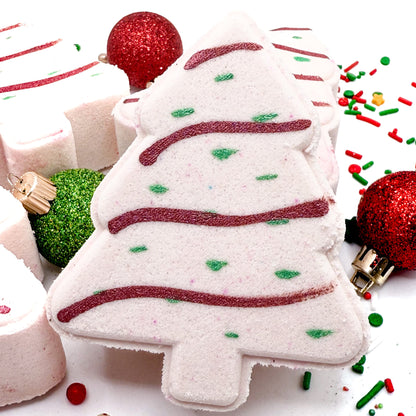 Christmas tree shaped bath bomb with festive decorations on a white background