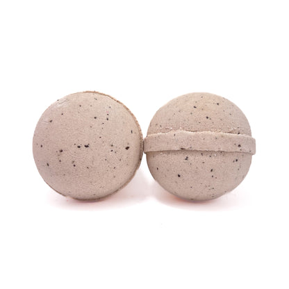 Two round coffee bath bombs lite tan in color with coffee bean specks throughout. 