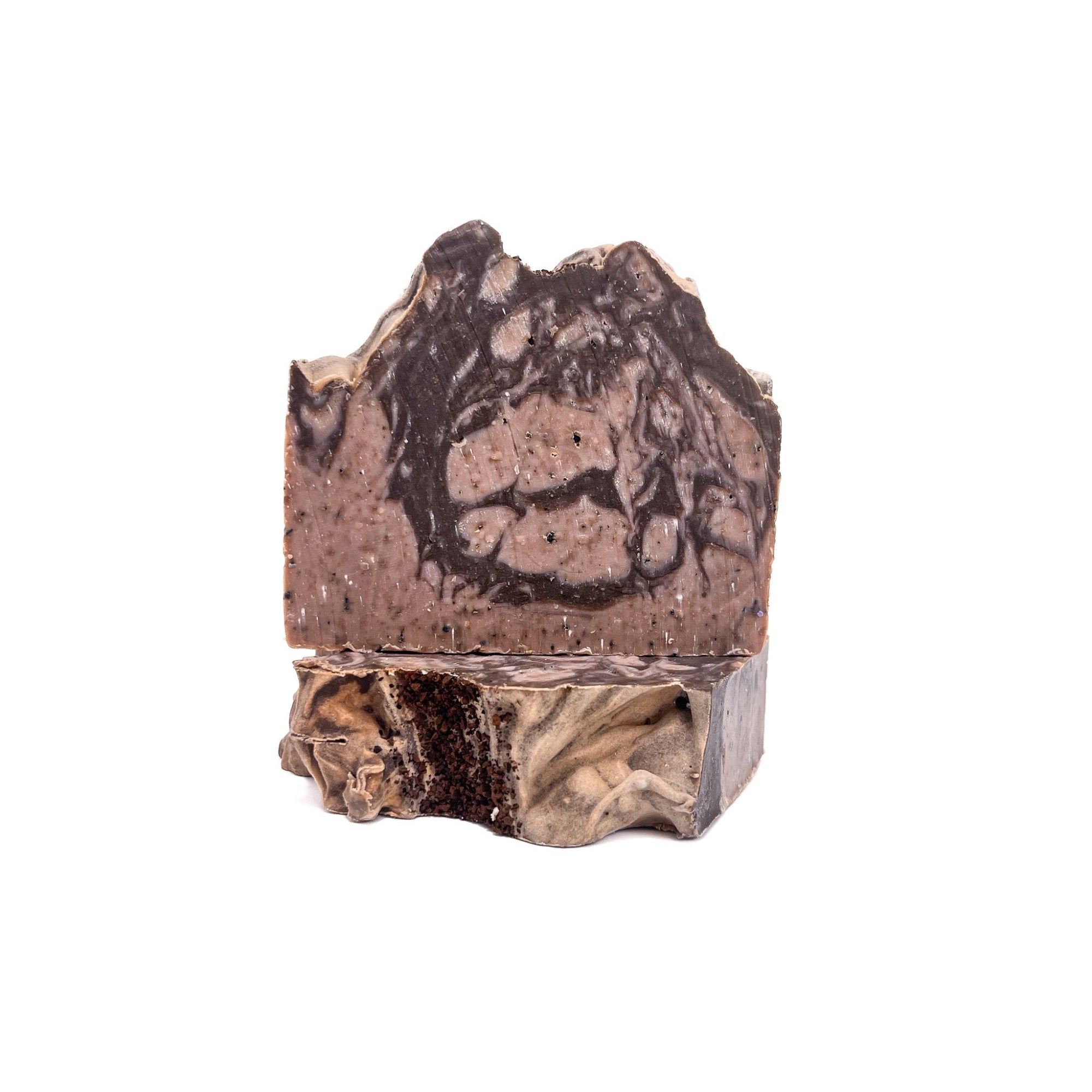 Two bars of coffee scented handmade bar soap. Swirled tan and brown, topped with a sprinkle of coffee grounds.