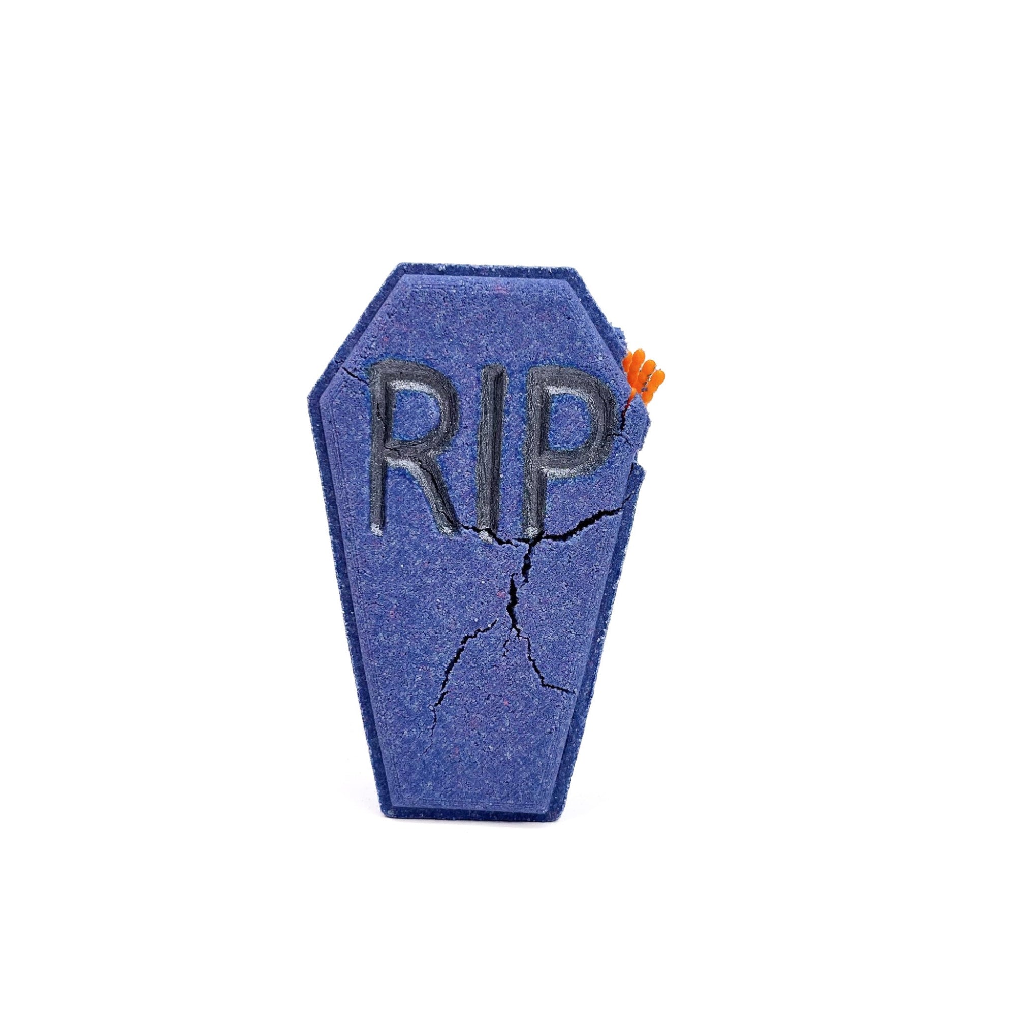 A dark blue-purple coffin with an orange hand sticking out. The letters RIP embossed on the front. 