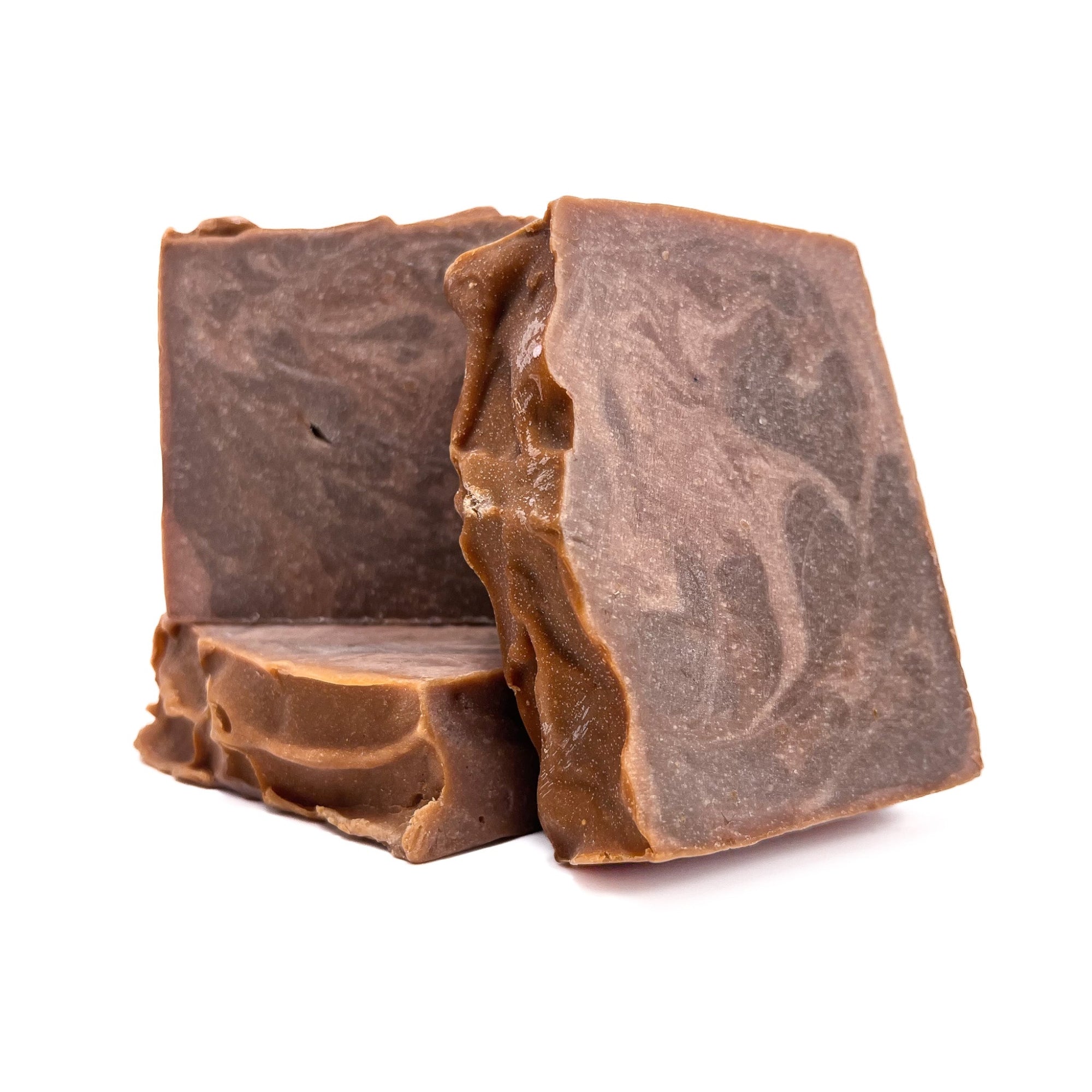 Three bars of handmade Cowboy soap. Swirled dark brown and light brown like leather! One upright and two flat to show texture.