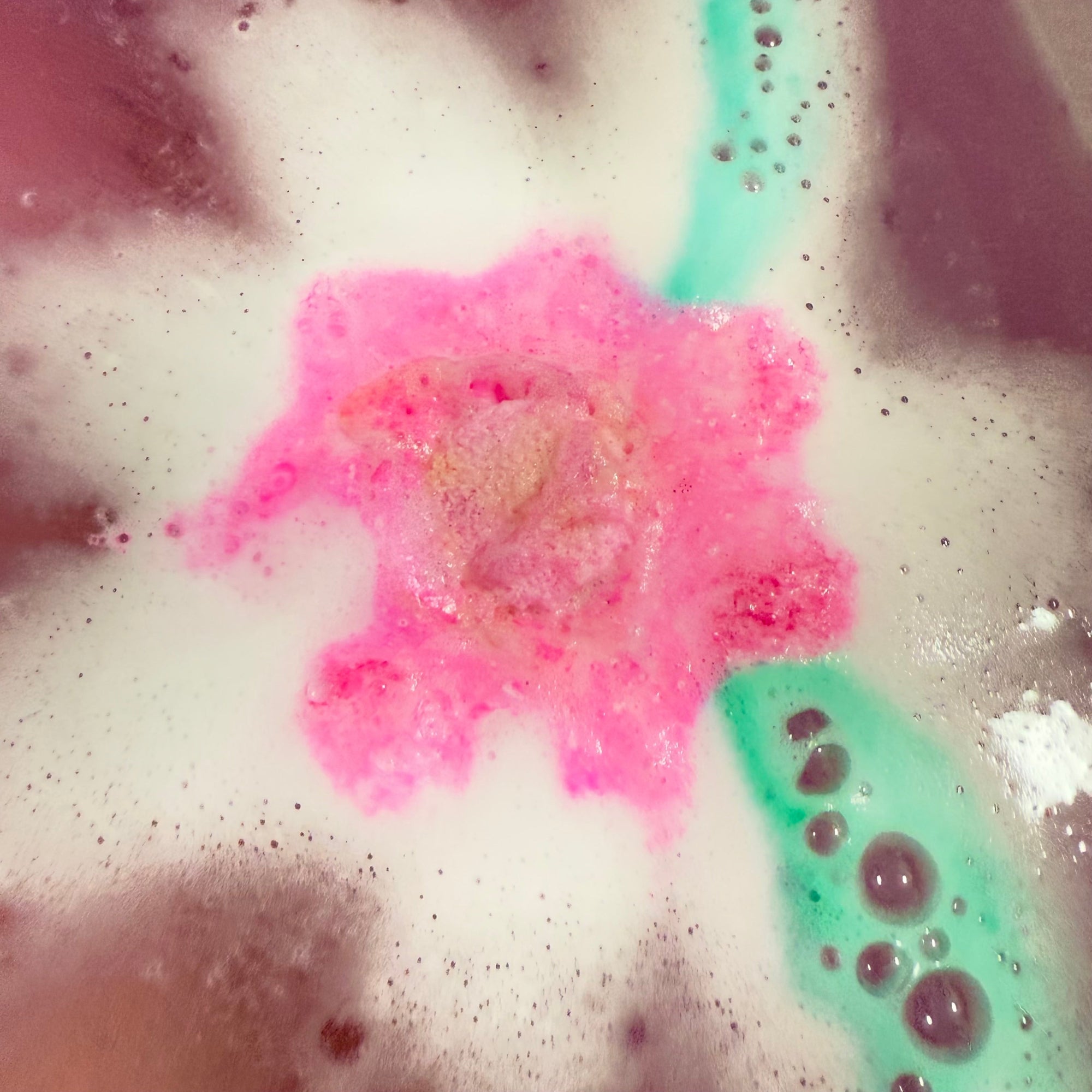 Daisy bath bomb in action, made by Rusted Acre Soap Company.