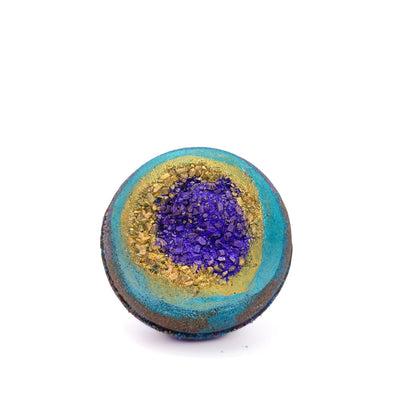 Round bath bomb swirled with black and teal embedded with gold sea salt. 