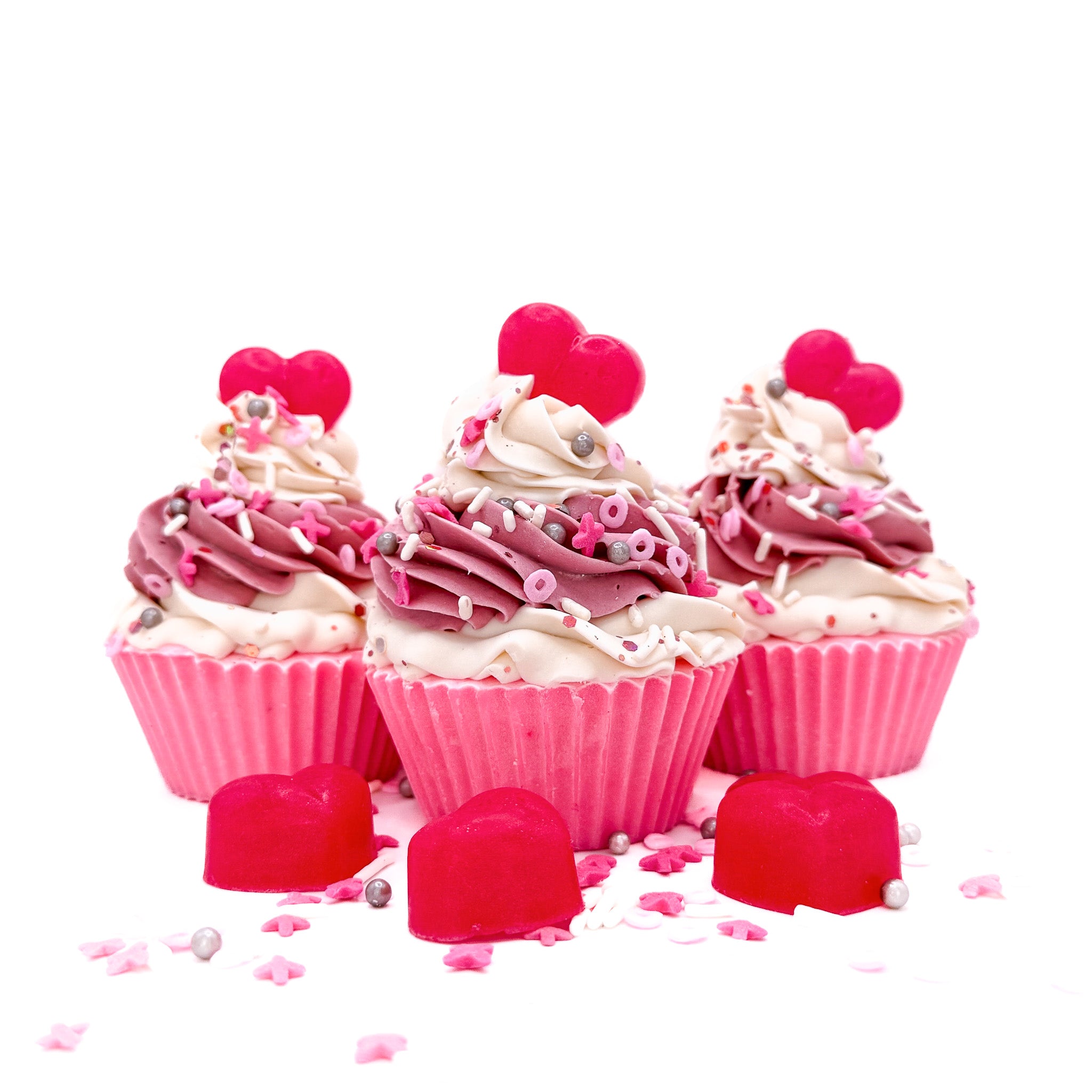 Three heart cupcake soaps from Rusted Acre Soap Co. Pink cake topped with pink and white frosting and pink heart soap embeds.