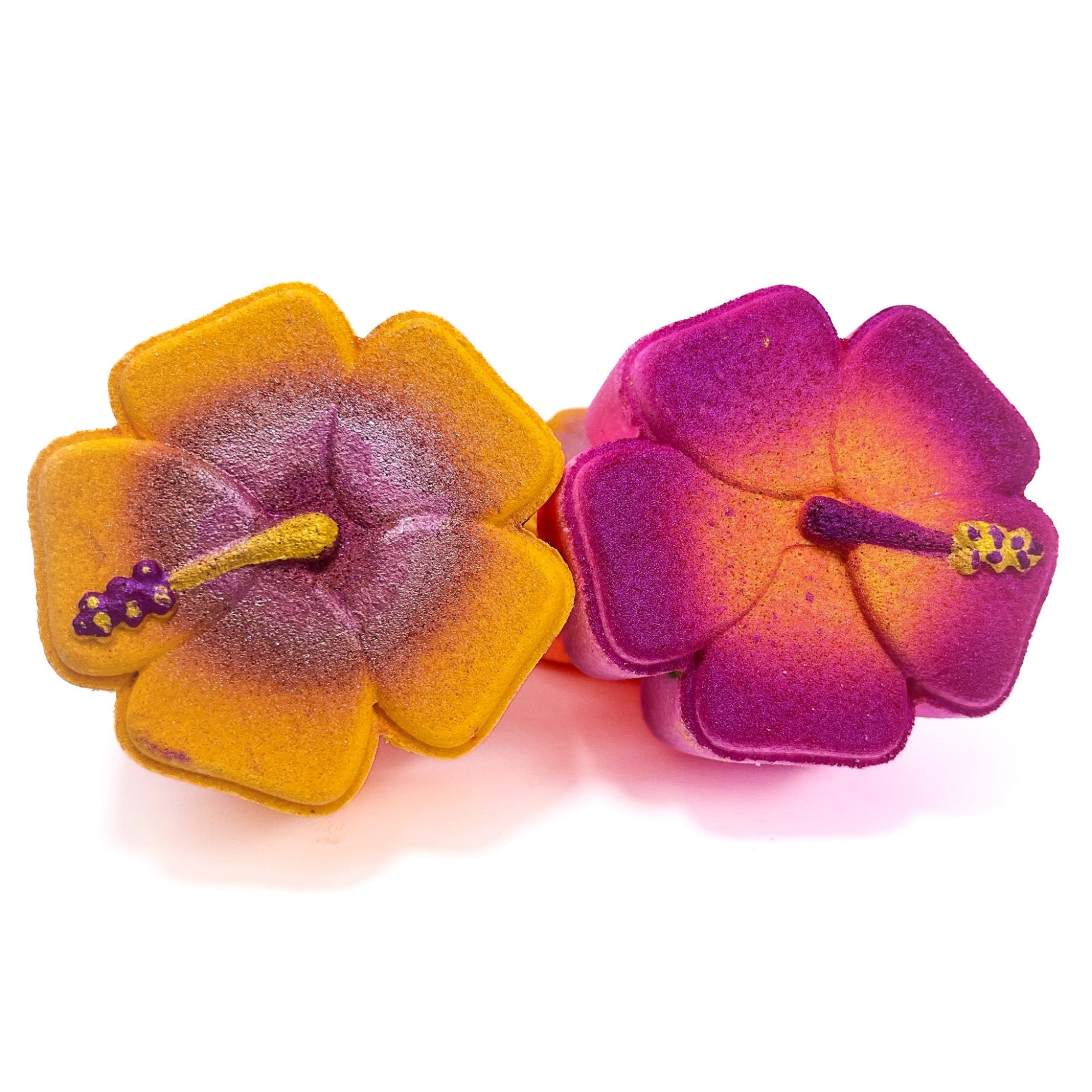 Two of Rusted Acre Soap Company's hibiscus bath bombs. One pink and one orange. 