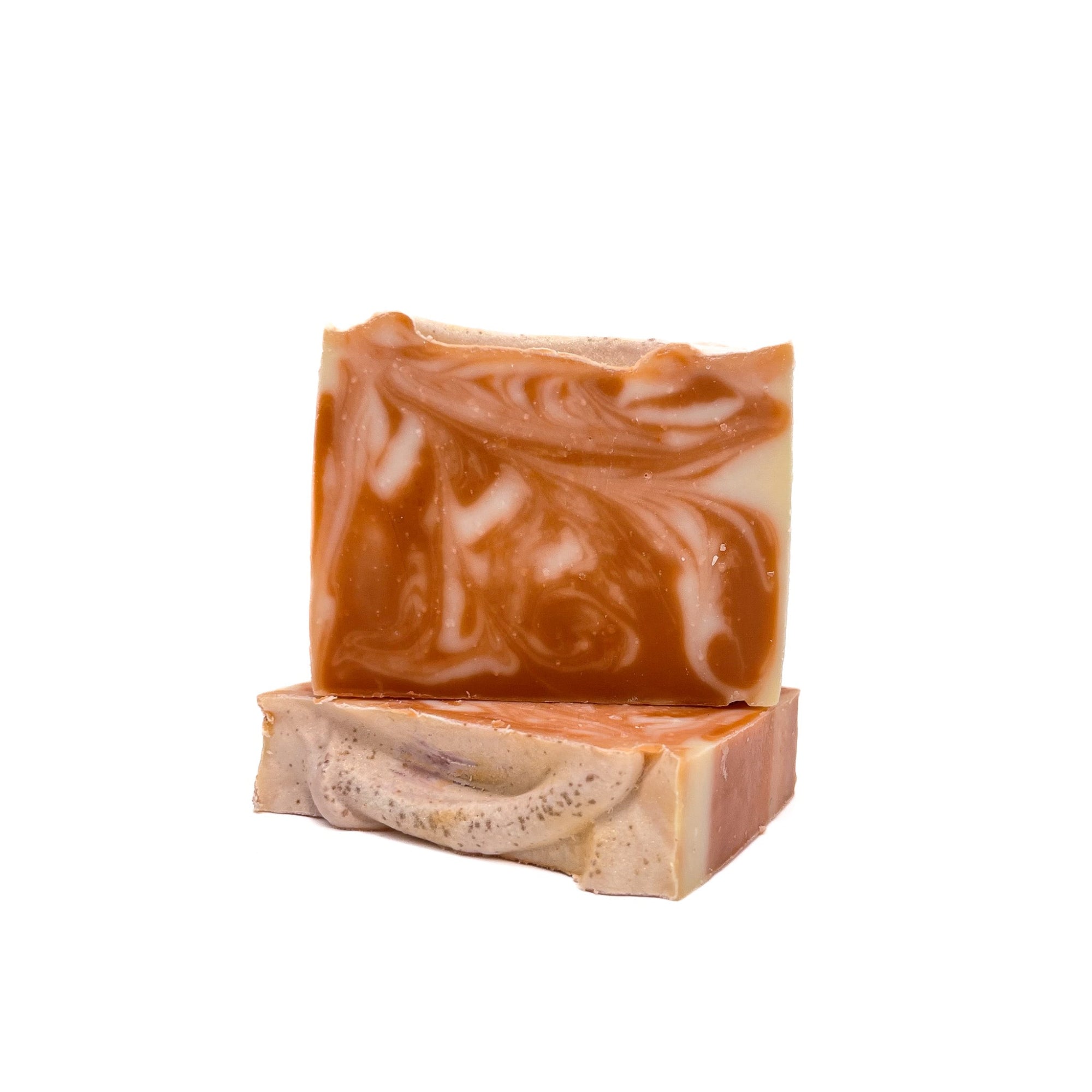 Two bars of deep purple-red and white swirled handmade soap from Rusted Acre Soap Co. One lying flat, one upright. 