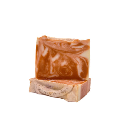 Two bars of deep purple-red and white swirled handmade soap from Rusted Acre Soap Co. One lying flat, one upright. 