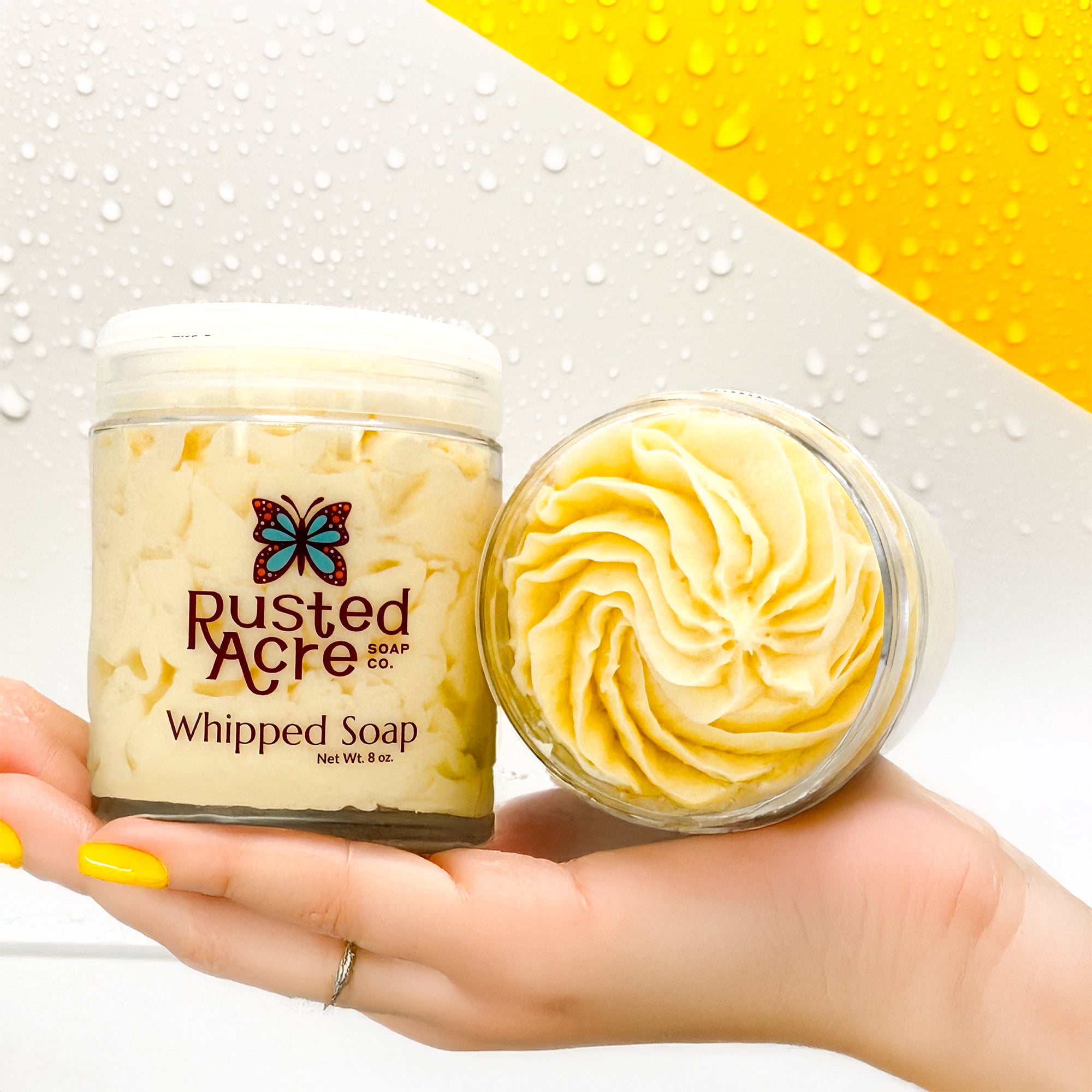 Two jars of Rusted Acre Soap Company's lemon cupcake whipped soap in a lifestyle image.