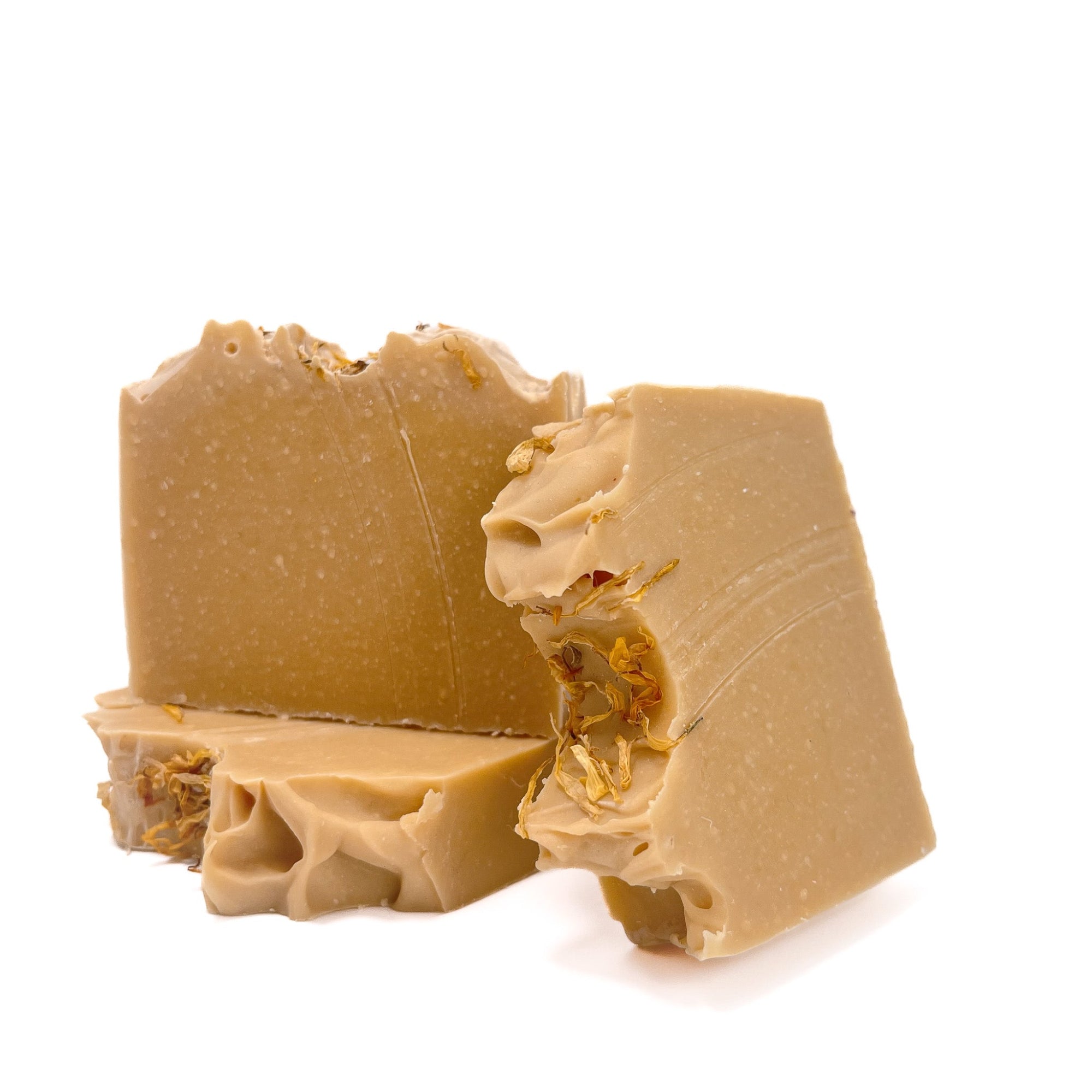 Three bars of lemon scented handmade soap. Yellow in color, sprinkled with yellow petals, decorative artisan top.