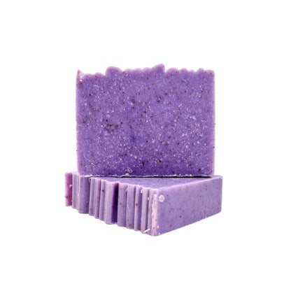 Two bars of handmade lilac purple soap with textured top from Rusted Acre Soap Company. 