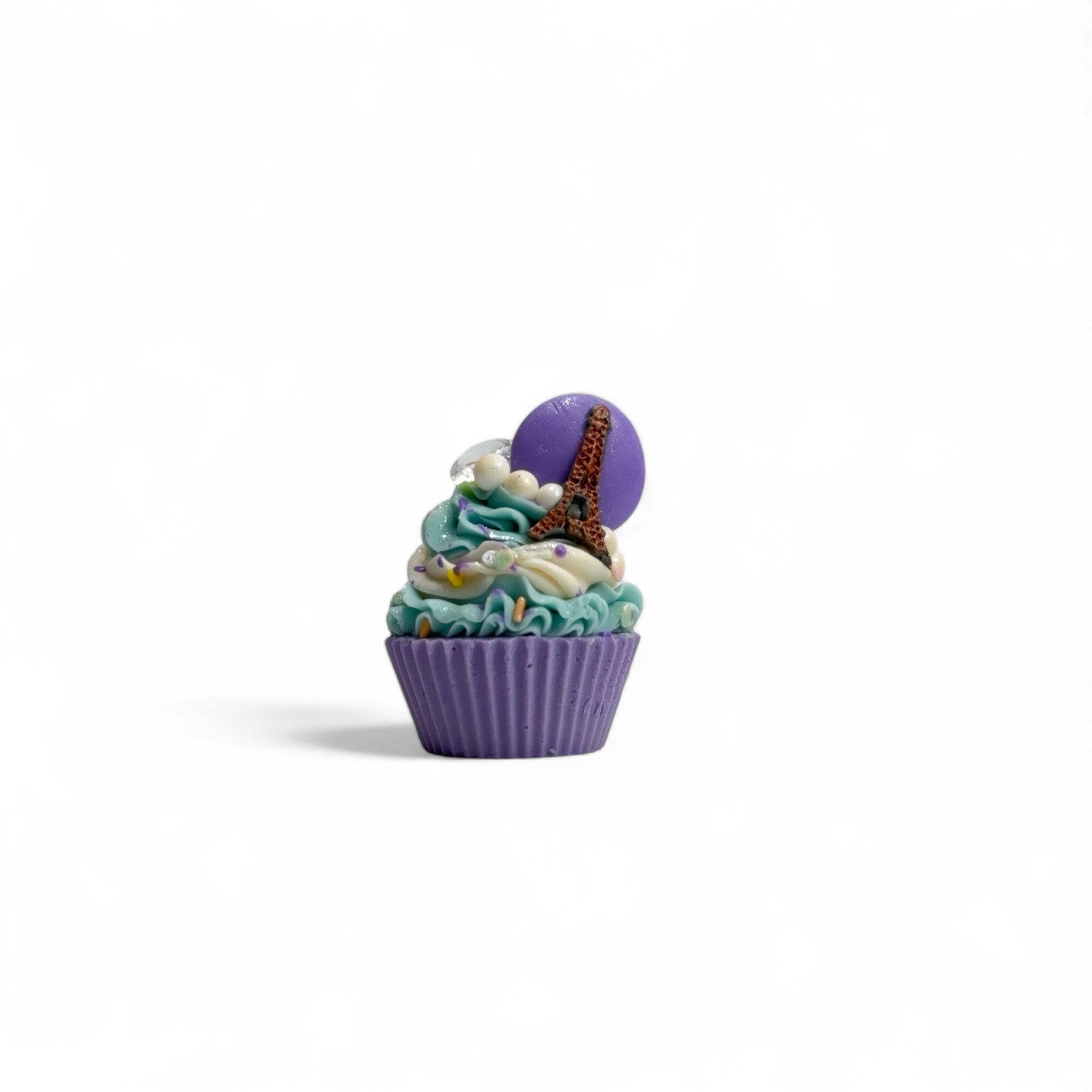 A purple pink and teal, Paris inspired cupcake soap handmade by Rusted Acre Soap Co. Topped with a pastel macaron and Eiffel Tower soap. 