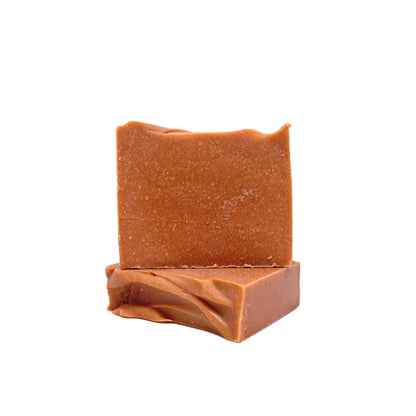 Two bars of Rusted Acre Soap Company's Mahogany handmade soap. Color is brownish-red. One flat, one upright to show texture. 