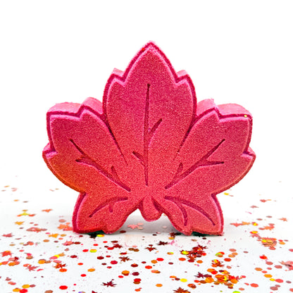 One maple leaf shaped, pumpkin pecan waffle scent bath bomb. Airbrushed with gold on left, reds in center, and green right.