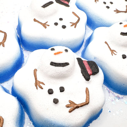 Close-up of Rusted Acre Soap Companies melting snowmen bath bomb with blue accents.