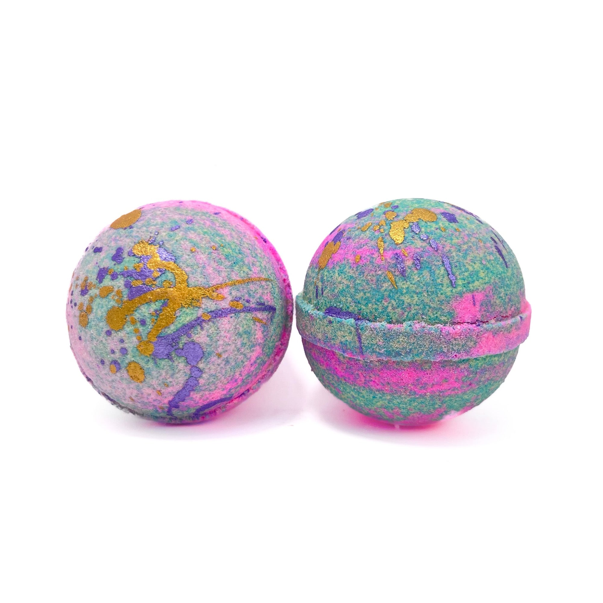 Two pink and teal swirled round bath bombs. Hand-splattered with gold and purple mica.