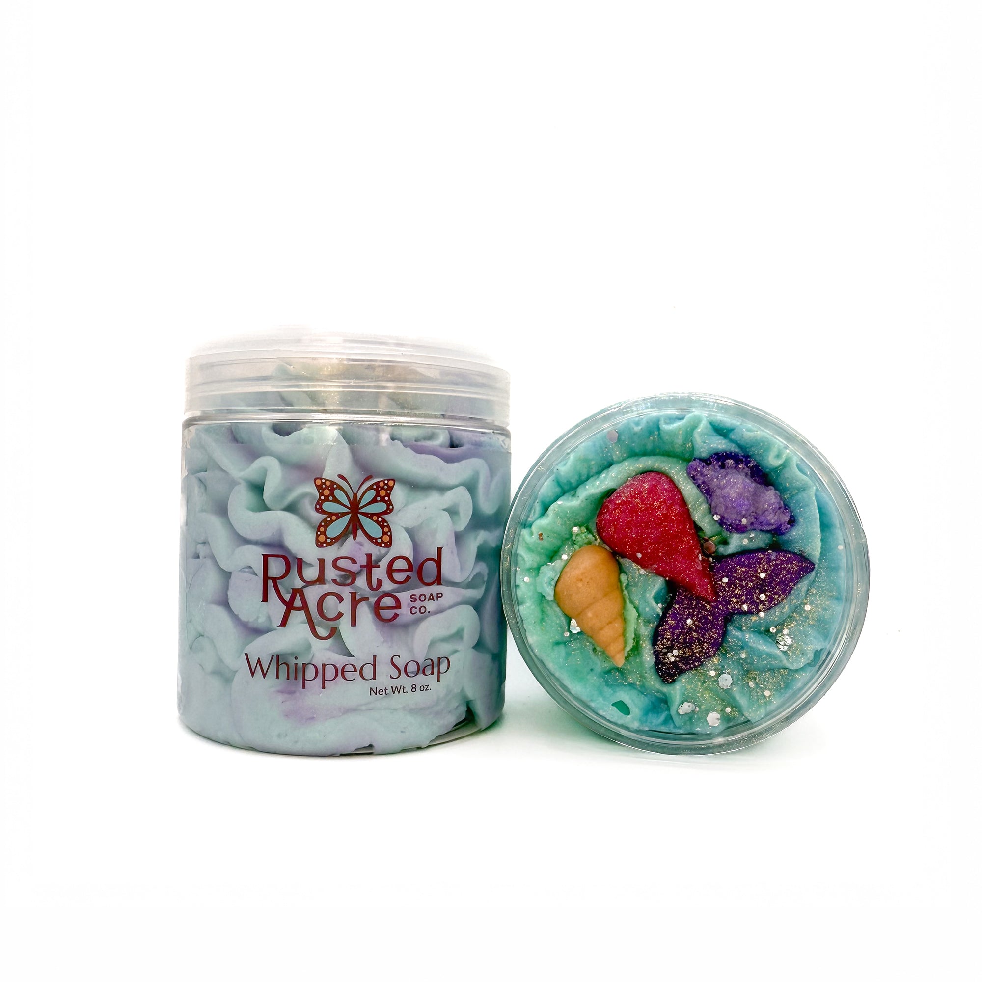 Two jars of Rusted Acre Soap Company’s mermaid kiss whipped soap front and top view.