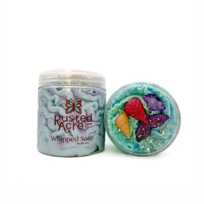 Two jars of Rusted Acre Soap Company’s mermaid kiss whipped soap front and top view.