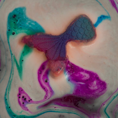 Rusted Acre Soap Companies Mermaid tail bath bomb putting on a color show.