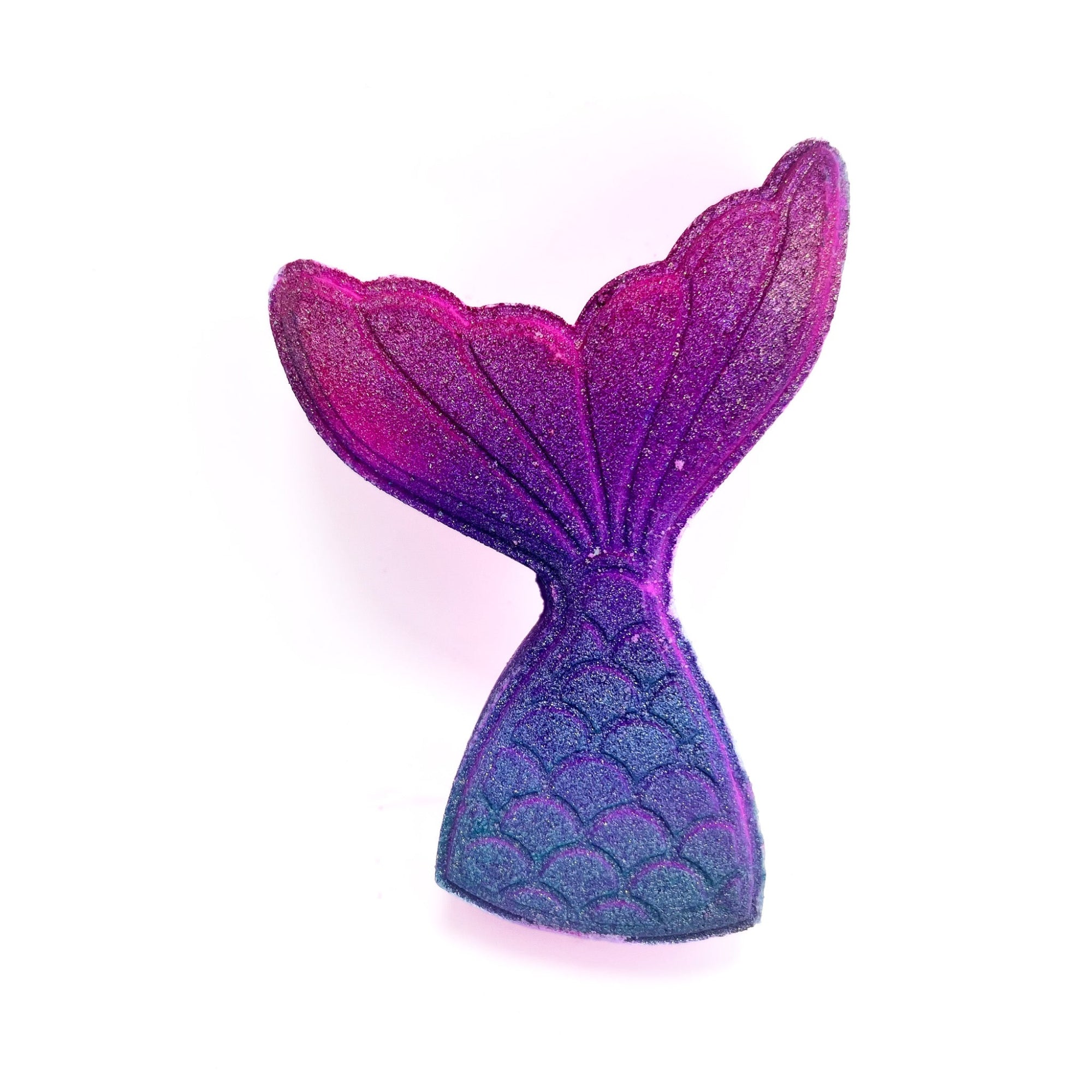 A pink and teal swirled mermaid tail shaped bath bomb. 