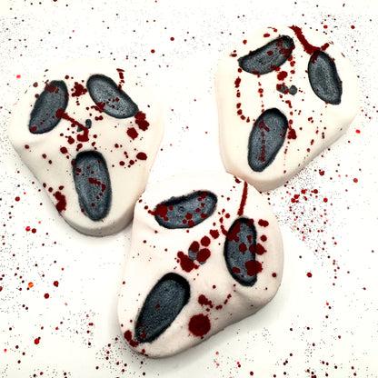 Set of three Midnight Caller horror-themed bath bombs, each with black facial features and red splatter accents.Handmade by Rusted Acre Soap Company. 