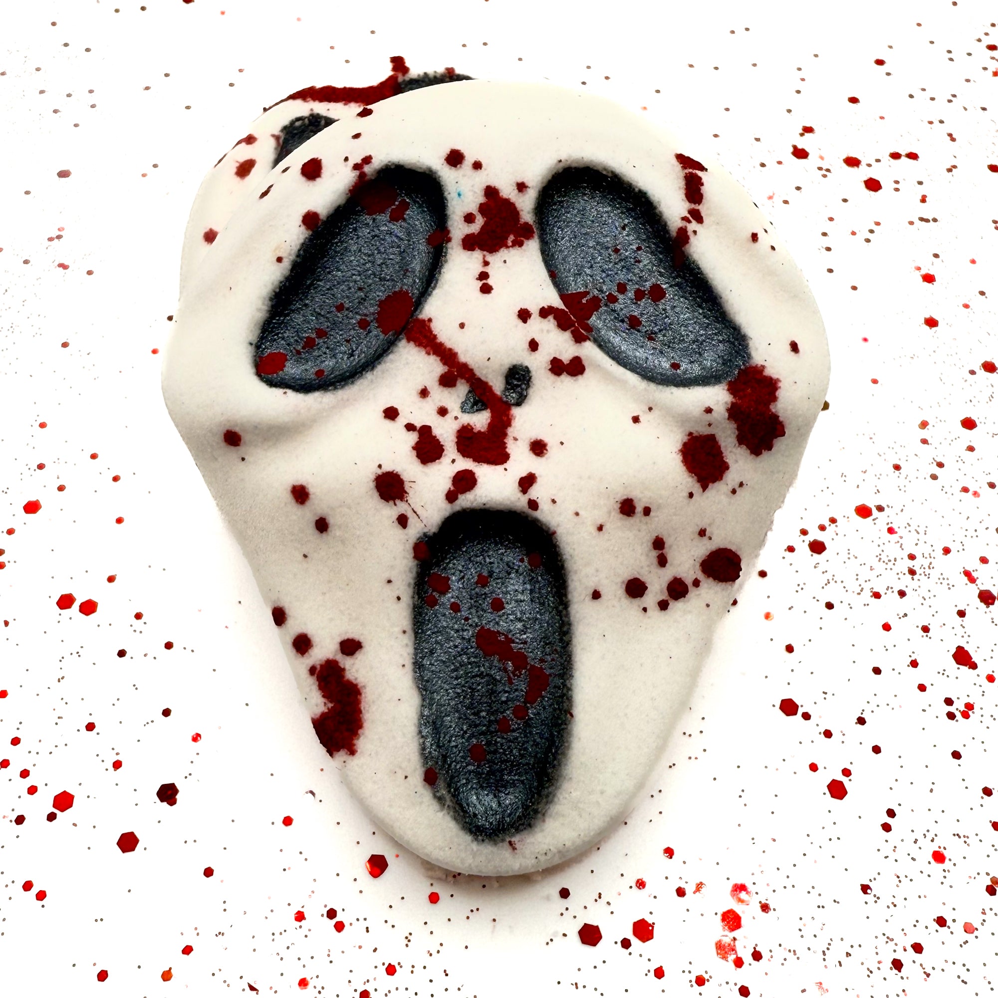 Front view of Midnight Caller bath bomb on white background with blood splatter effect. Handmade by Rusted Acre Soap Company. 