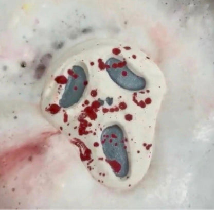 Midnight Caller horror-inspired bath bomb fizzing in the water, releasing red splatter colors and dark accents.