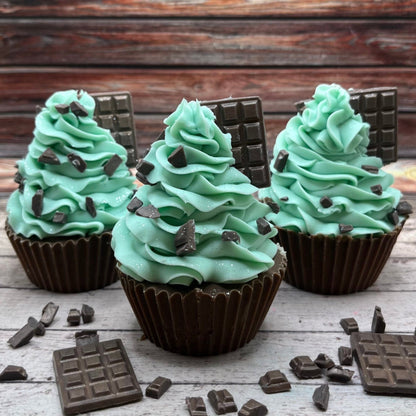 Three mint chocolate cupcake soaps being delayed on a rustic wood background. Cupcake soaps make by Rusted Acre Soap Co