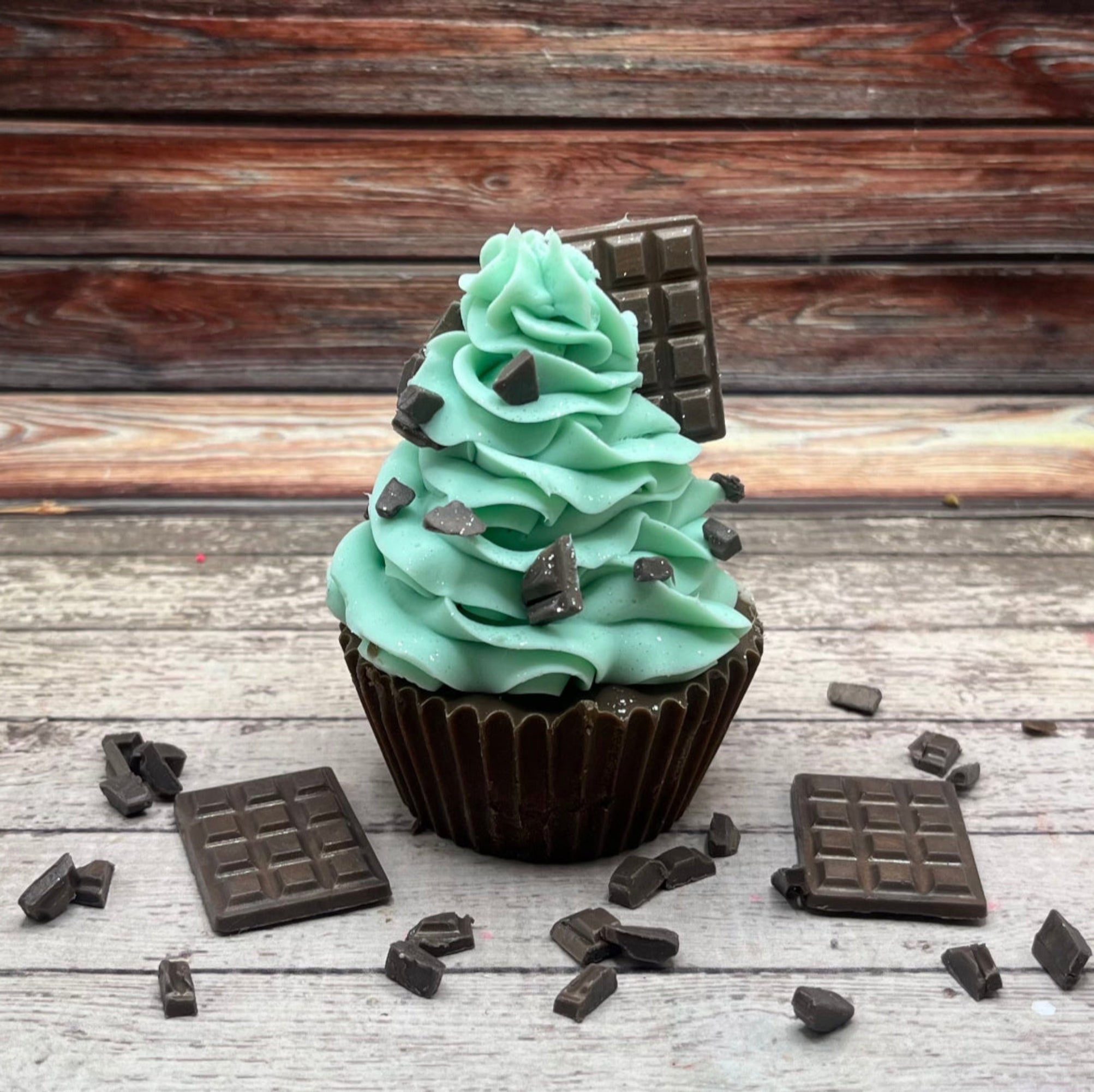 A mint chocolate cupcake soap from Rusted Acre Soap Co. Chocolate colored cake with mint green frosting sprinkled with soap chips.