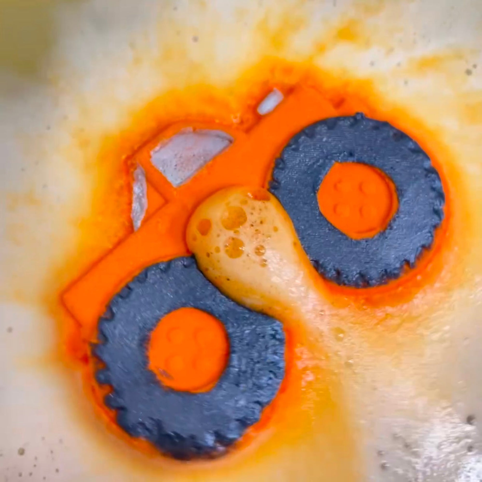 Rusted Acre Soap Companies orange monster truck bath bomb putting on a color show.