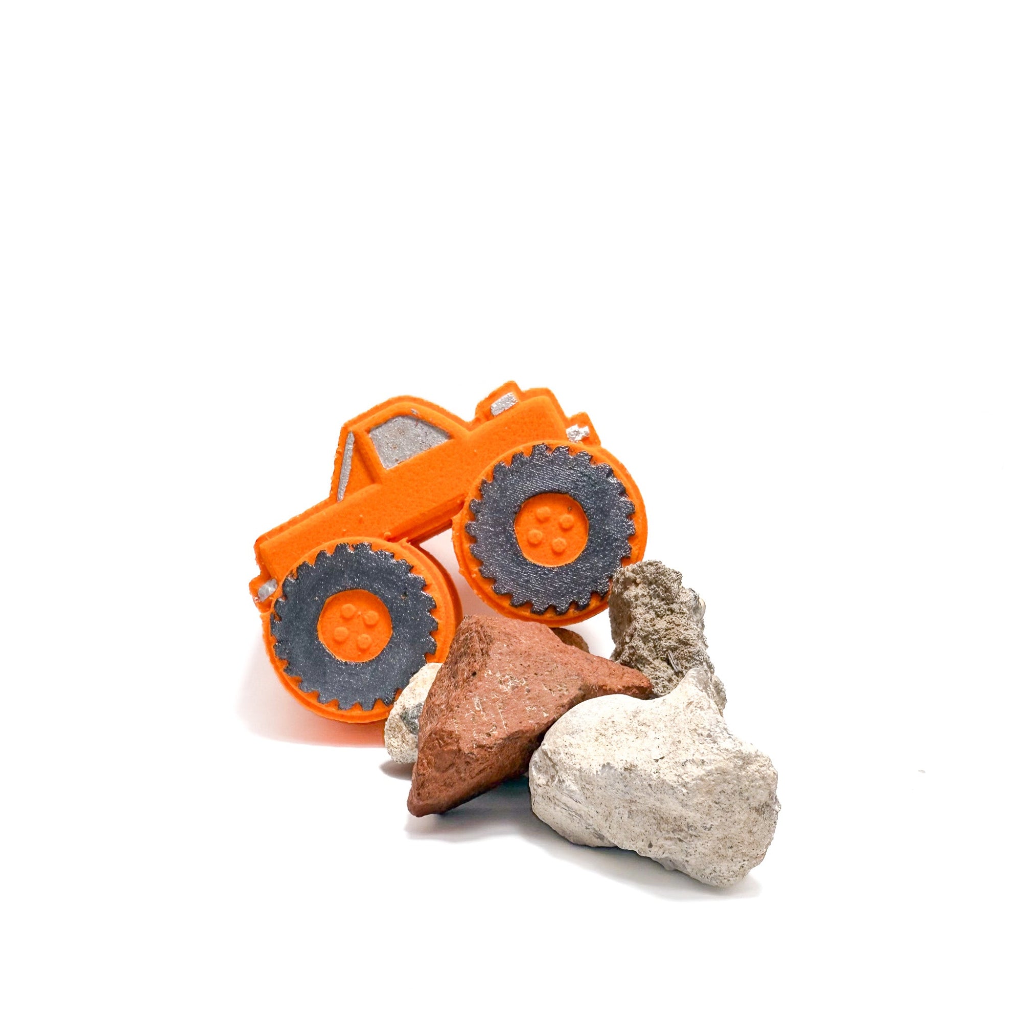 An orange monster truck bath bomb handmade by Rusted Acre Soap Co