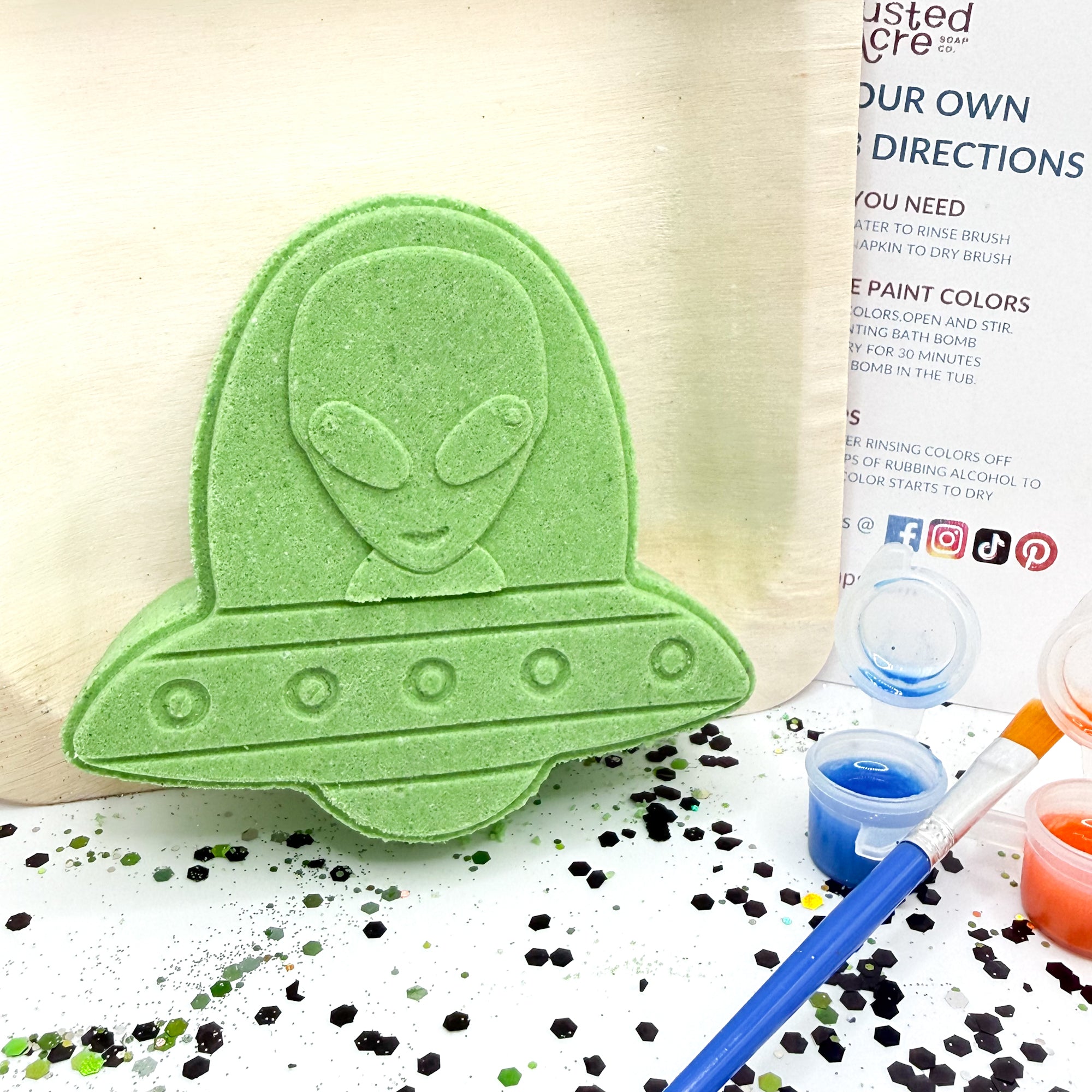 Alien, paint your own bath bomb kit. It comes as a blank white bath bomb canvas along with 3 random colors in pot, paint brush, witch hazel, and instructions.