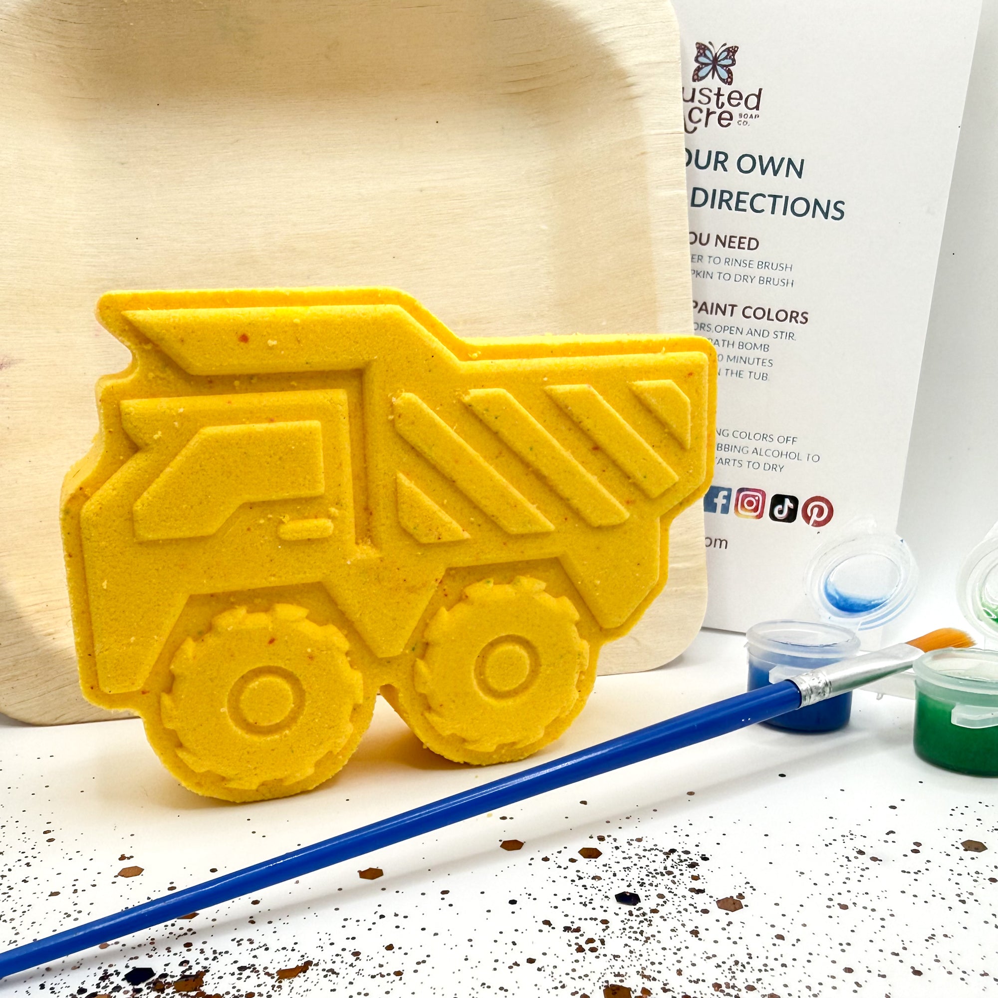 Yellow paint your own dump truck kit with paint and paint brush. 