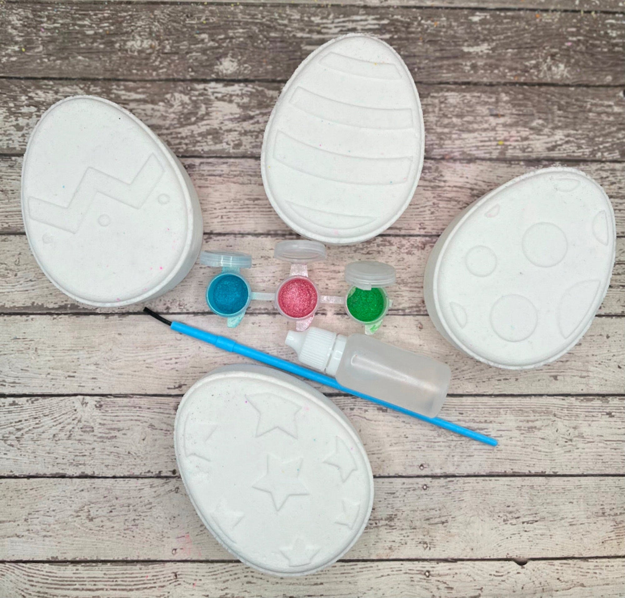 Paint your own easter egg kit with all eggs pictured, white bath bombs  and painting supplies. Made by Rusted Acre Soap Co.