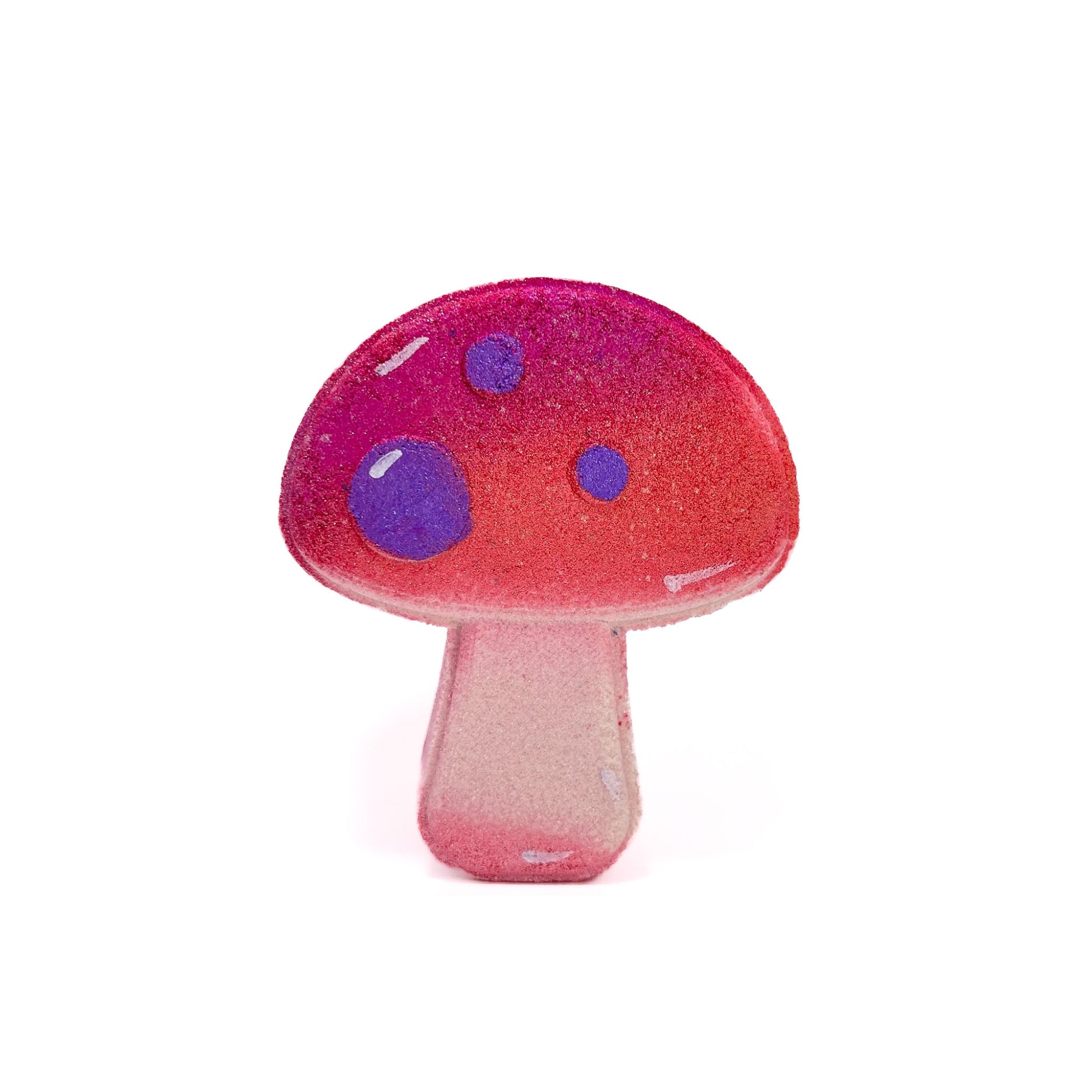 A mushroom shaped bath bomb, airbrushed shimmery pink. Hand-painted purple dots by Rusted Acre Soap Co.