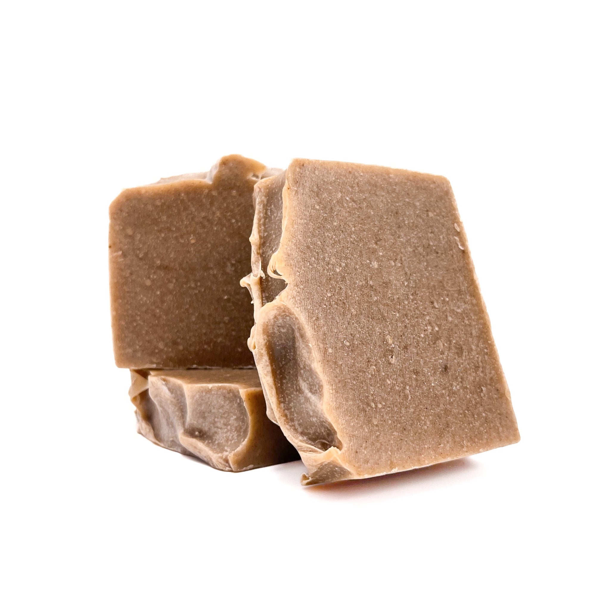 Three bars of dark tan pomegranate handmade soap from Rusted Acre Soap Company.
