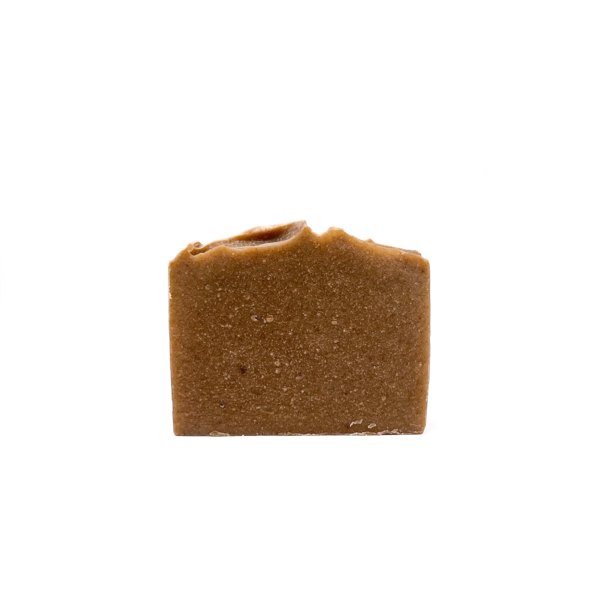 A bar of dark pastel yellow natural handmade soap from Rusted Acre Soap Co. 