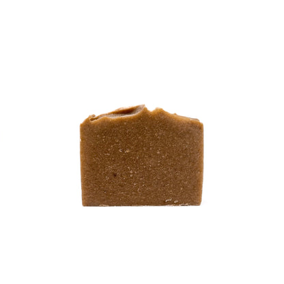 A bar of dark pastel yellow natural handmade soap from Rusted Acre Soap Co. 