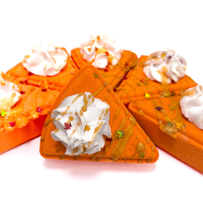 Pumpkin Pie bath bombs with whipped bubble bath frosting on a white background.